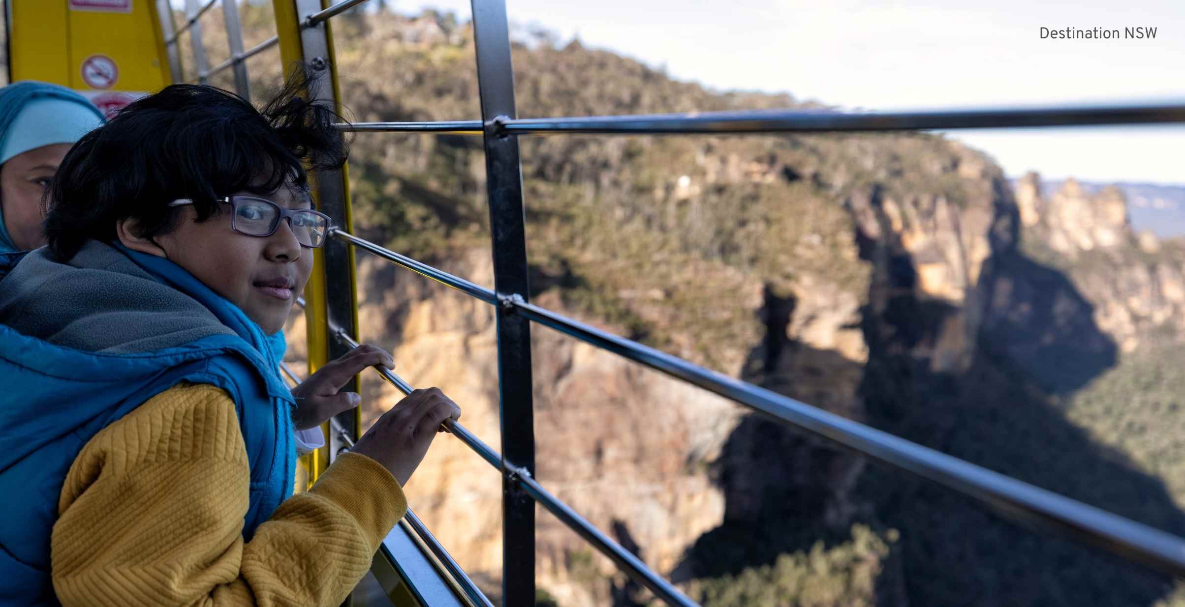 Young boy looking out from Sky Rail Gondola over the Blue Mountains