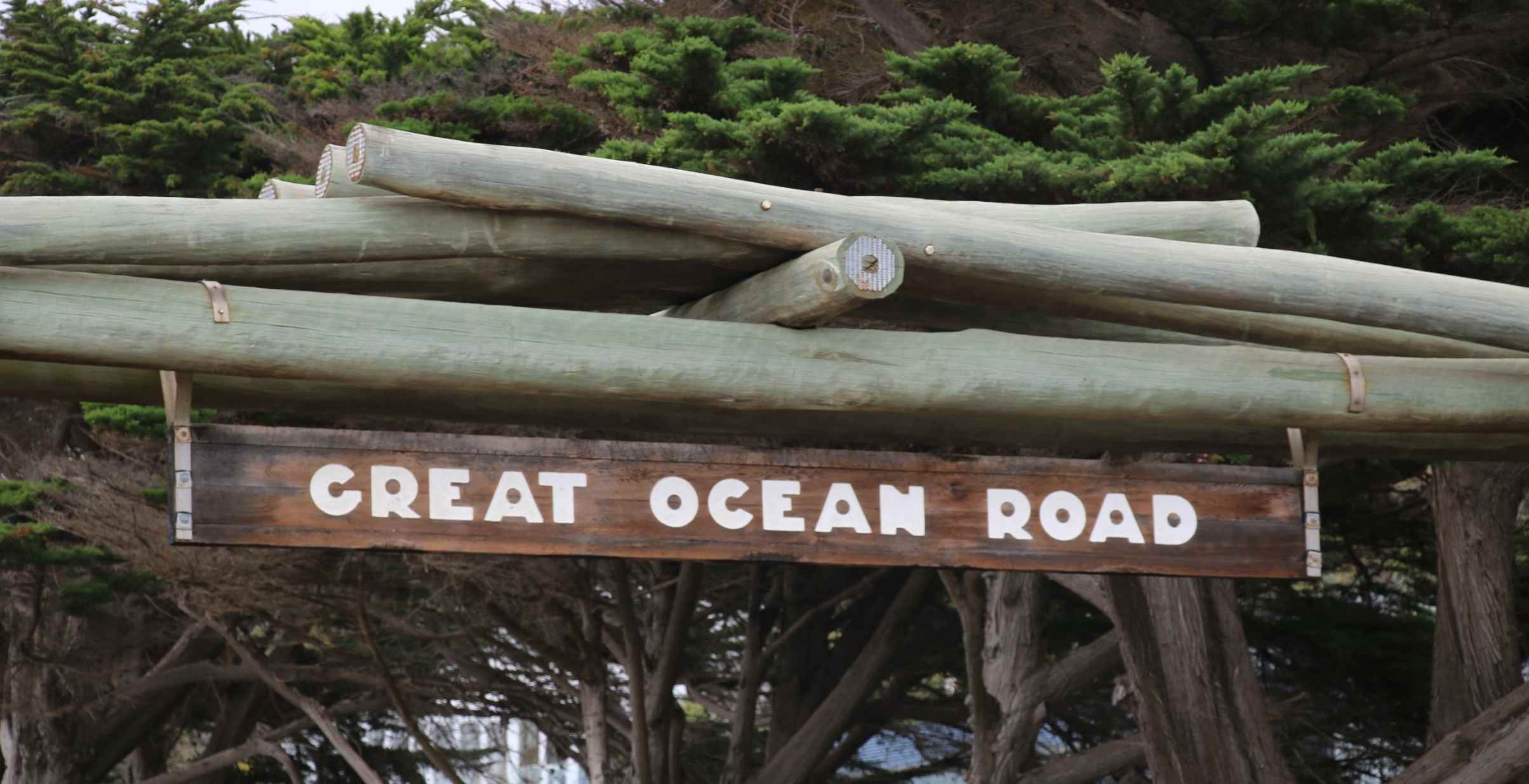 Close-up of Great Ocean Road wooden sign on the Memorial Arch.