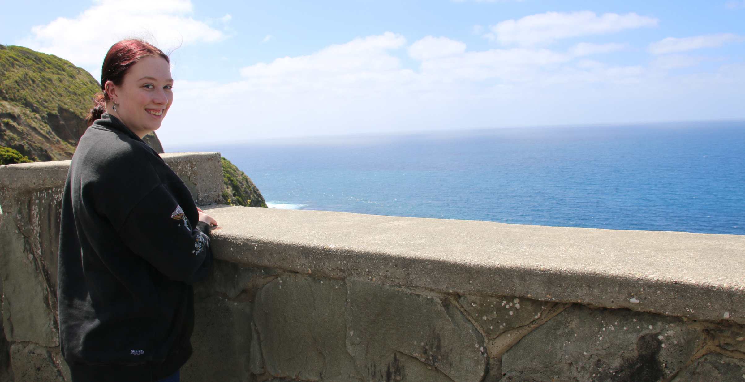 Woman Standing at a lookout point along the Great Ocean Road